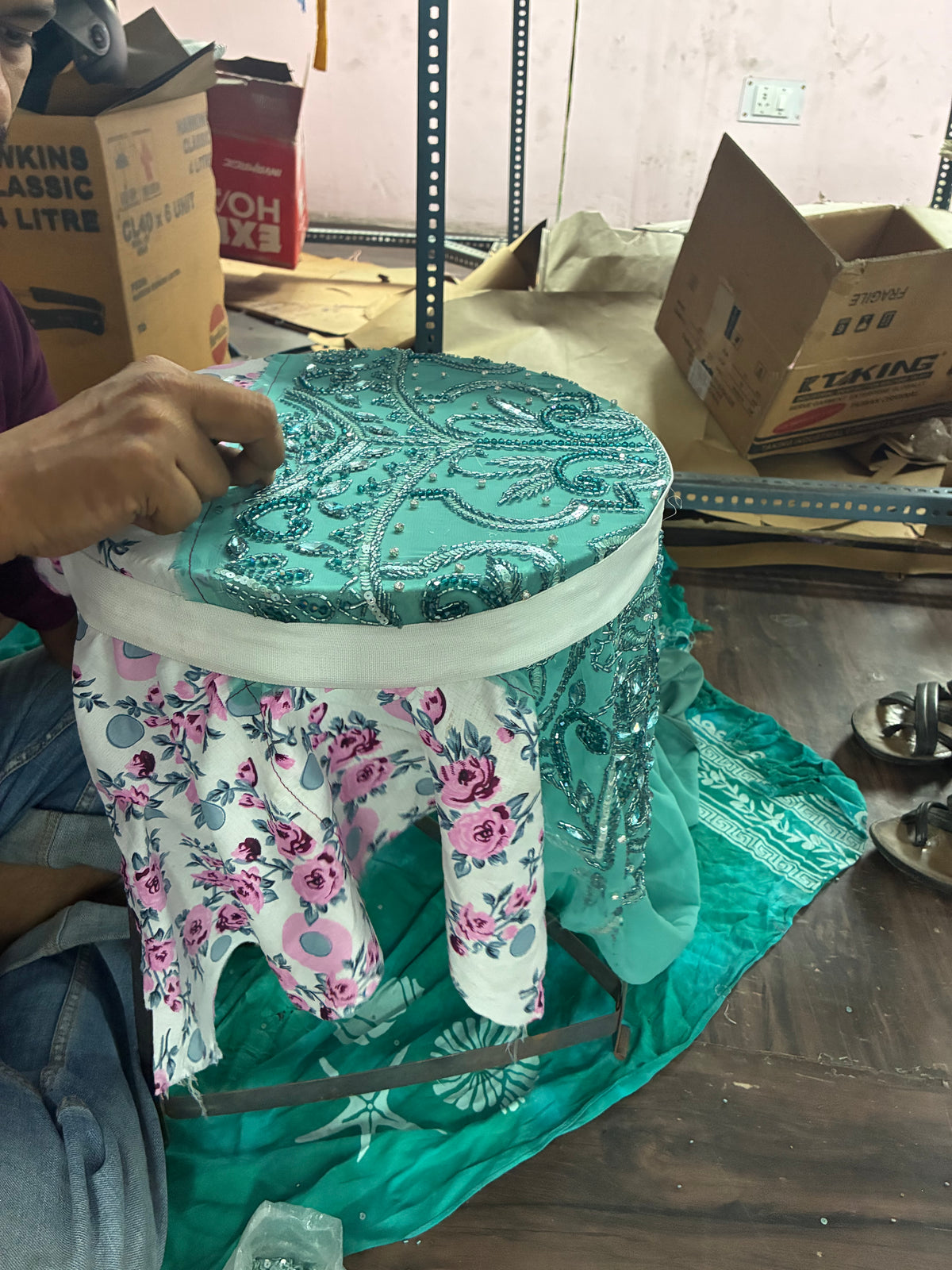 Skilled artisans creating luxury hand embroidery and traditional Adda work with zari, sequins, beads and pearls for couture fashion garments