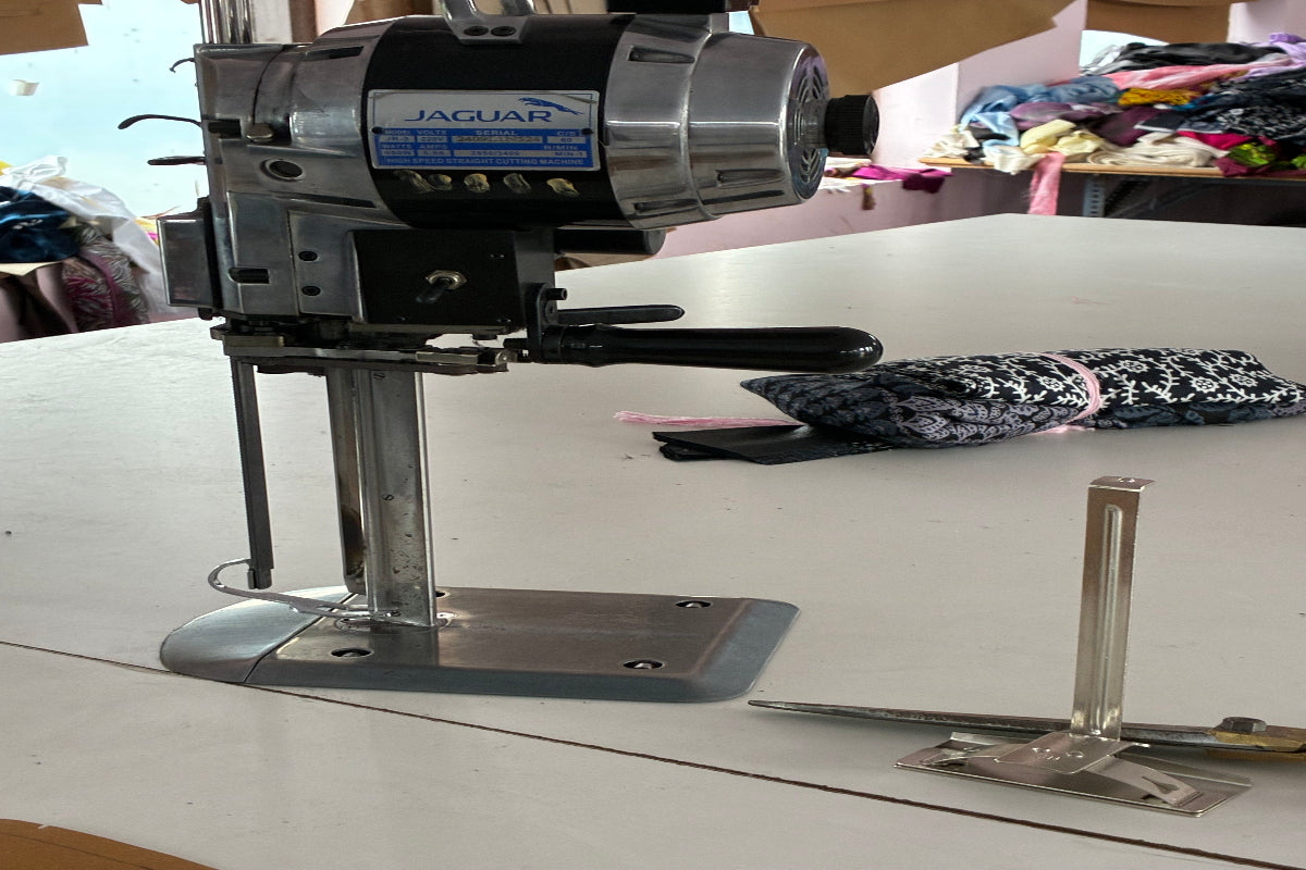 Industrial straight knife layer cutting machine cutting multiple fabric layers for precision garment manufacturing in India